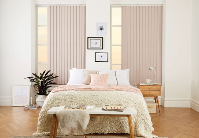 White vertical blinds in a bedroom
